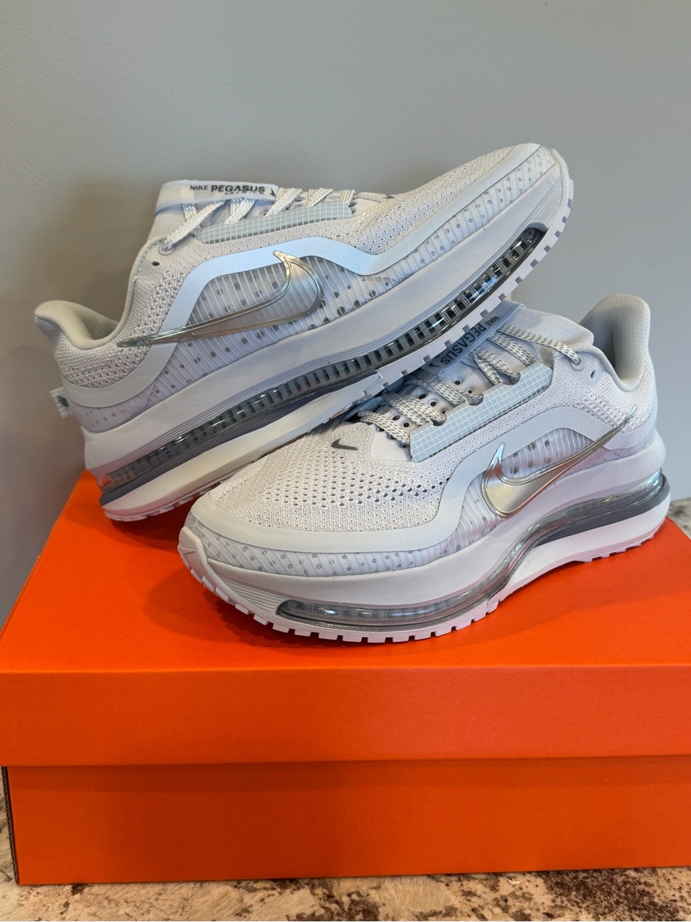Nike Women’s White Sneakers with Metallic Silver Swoosh